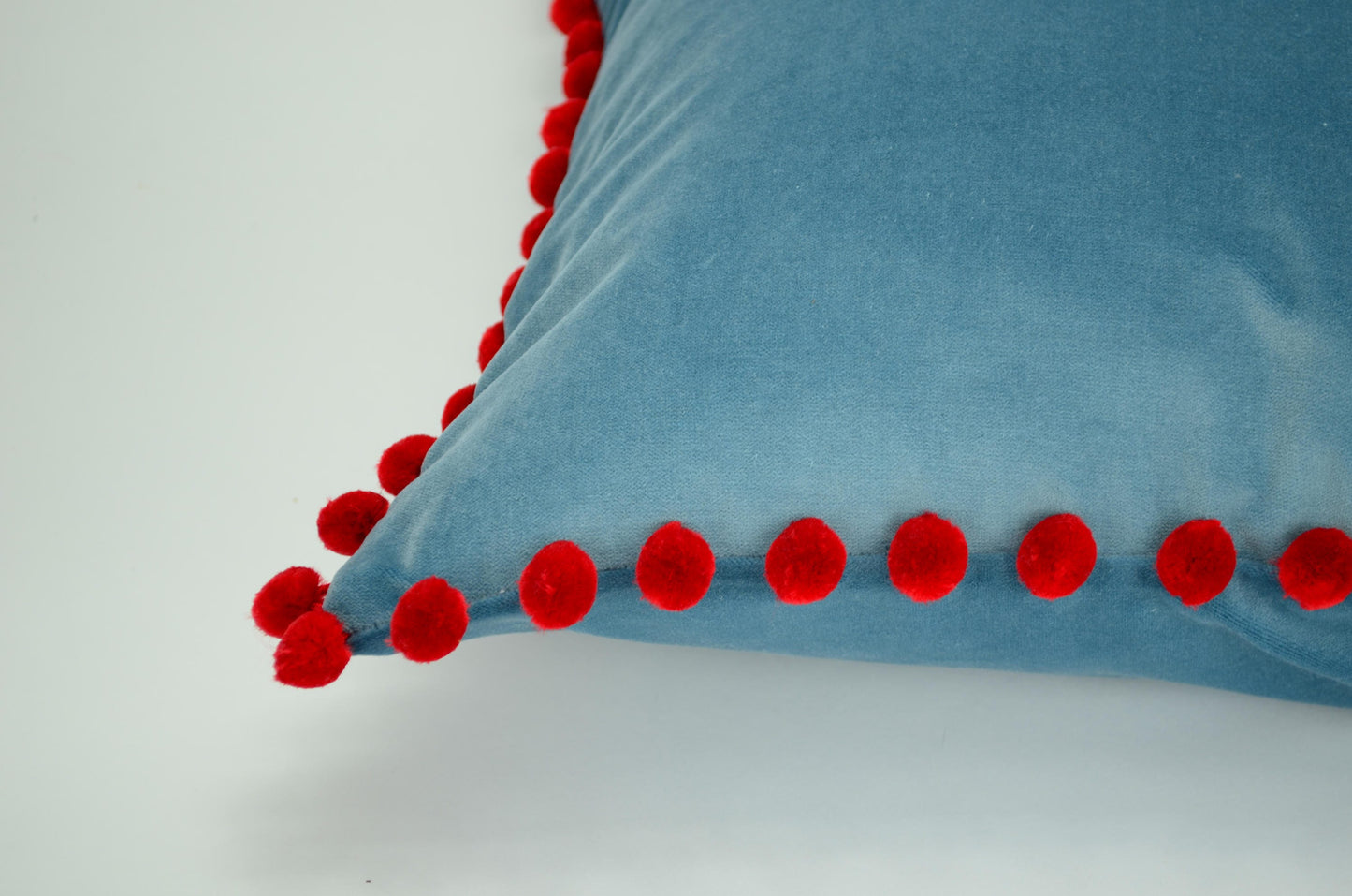 Blue velvet pillow with red pom poms // blue and red pillow // velvet pom pom pillow //  pom pom pillow // pom pom cushion